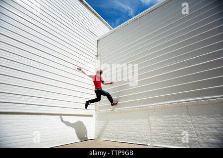 Low angle view of man sur mur blanc Banque D'Images