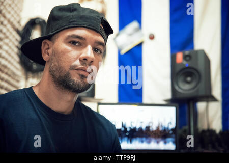 Portrait de jockey radio assis en studio Banque D'Images