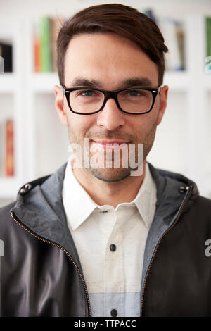 Close-up portrait of businessman smiling at home Banque D'Images