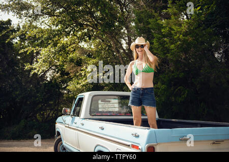 Woman in Sunglasses and hat standing sur pick-up Truck Banque D'Images
