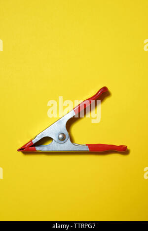 High angle view of clothes peg sur fond jaune Banque D'Images