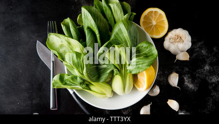 Vue aérienne de bok choy avec citron et l'ail sur la table Banque D'Images