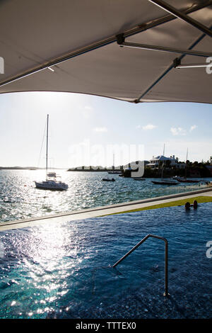 Les Bermudes. La piscine à débordement à la Hamilton Princess & Beach Club Hotel. Le port de Hamilton peut être vu dans l'arrière-plan. Banque D'Images