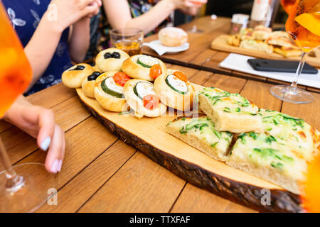 Diverses collations avec aperol spritz cocktail sur table en bois dans un café Banque D'Images