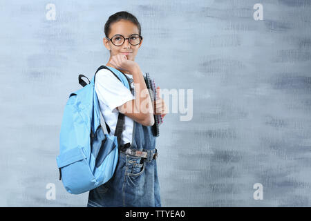 Cute schoolgirl sur un fond de couleur Banque D'Images