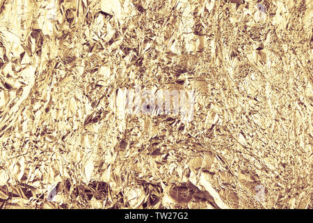 Résumé fond aluminium froissé. Grunge background photo. Couleurs d'or. Banque D'Images