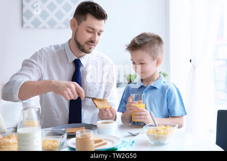 Père et fils en train de déjeuner à la maison Banque D'Images