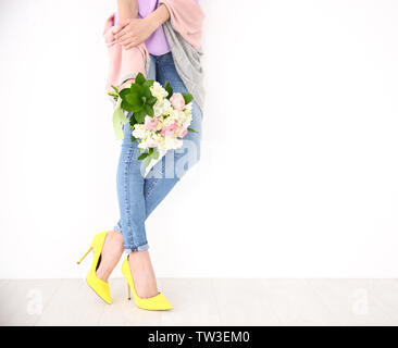 Young woman holding bouquet avec des fleurs de freesia sur fond blanc Banque D'Images