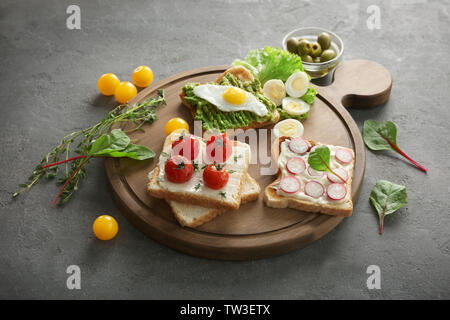 Petit-déjeuner savoureux toasts avec différents légumes sur le tableau Banque D'Images