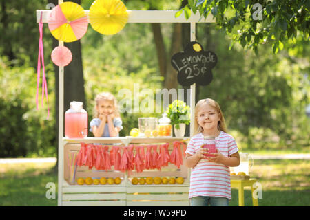 Adorable petite fille avec pot près de visiteurs le parc de Banque D'Images