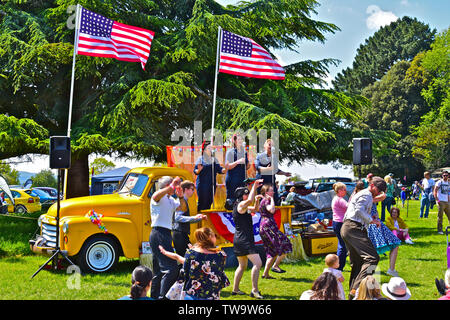 'La liberté Sisters' trio vocal effectuant de succès américains des années 20 s-30s à l'arrière de la dépanneuse GMC classique au Classic Car Show.Les gens danser/ regarder Banque D'Images