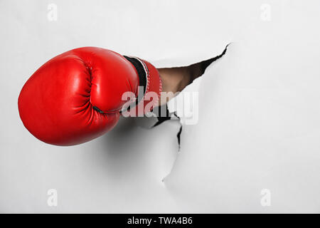 Man in boxing glove briser livre blanc Banque D'Images