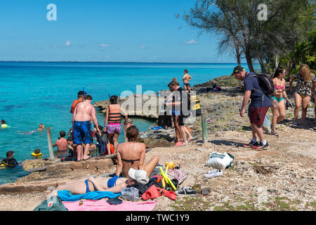 Les touristes d'entrer dans la mer pour faire de la plongée avec tuba et la plongée en face de la grotte de poissons (Cueva de los Peses) Playa Larga, Cuba Banque D'Images