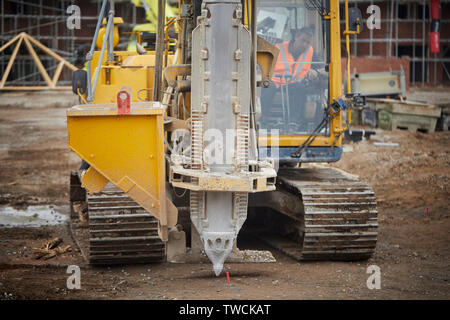 Pile Driver rig au travail sur un chantier de construction pour les nouvelles maisons en pierre dans le forçage de Cheshire fondations Banque D'Images