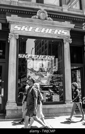 New York, 15/06/2019 : les gens à pied par un magasin Skechers dans SoHo. Banque D'Images