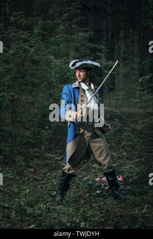 L'homme habillé en soldat de la guerre d'indépendance USA attaque avec sabre au combat. 4 juillet Jour de l'indépendance des USA concept composition photo : soldat, pis Banque D'Images