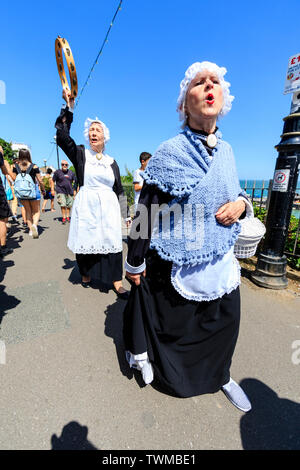 Festival annuel de Broadstairs Dickens. La marche de la femme militante. Groupe de personnes âgées, les femmes âgées, habillé en femme de chambre de style victorien, en marchant le long de la promenade de crier offres out. Banque D'Images