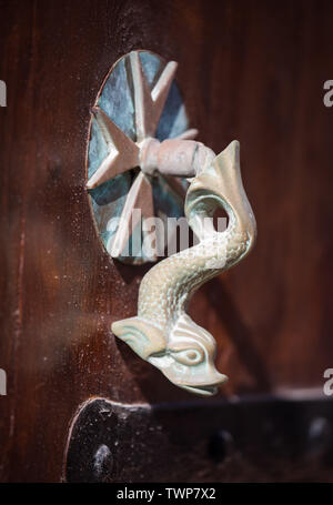 Poignée de porte ancienne dolphin avec croix de Malte sur la porte marron, La Valette, Malte. Banque D'Images