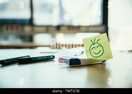 Smiley illustration à la place de travail, atelier. Stylos et fenêtre dans l'arrière-plan flou Banque D'Images