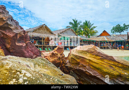 PHUKET, Thaïlande - Mai 1, 2019 : Le littoral des pierres sur la rive de Khai Nai surplombent la vieille huttes sur pilotis avec des cafés et restaurants, le 1er mai sur Banque D'Images