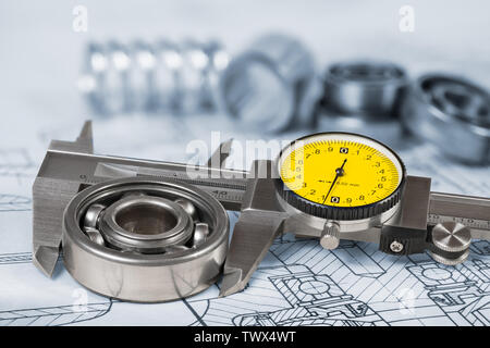 Mesure du diamètre du roulement à billes. Pied à coulisse sur le dessin technique. L'outil de mesure précis. Vernier, cadran rond jaune, groupe de parties en acier. Banque D'Images