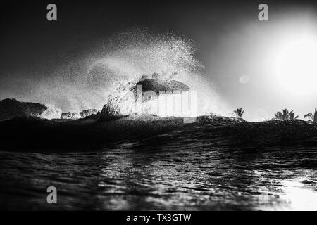 Surfer des vagues d'océan derrière l'air accrocheur au lever du soleil, Sayulita, Nayarit, Mexique Banque D'Images