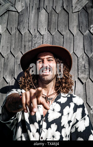 Portrait d'un homme portant un chapeau et chemise hawaïenne pointant sur viewer Banque D'Images