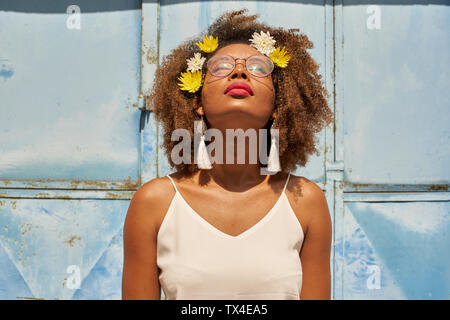 Portrait of young woman with red lips portant des lunettes et des fleurs dans les cheveux jusqu'à la Banque D'Images