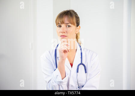 Une femme médecin dans son manteau blanc Banque D'Images