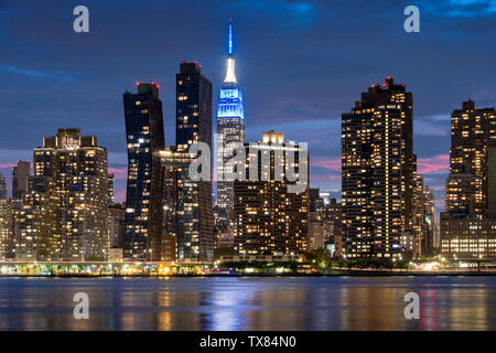 Manhatttan Skyline at night avec l'Empire State Building à travers l'East River, New York, USA Banque D'Images