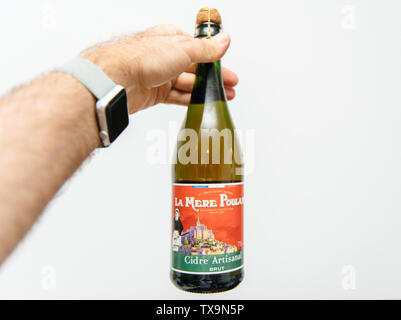 Lyon, France - Aug 15, 2018 : man main tenant avec bouteille de cidre traditionnel français brut cidre artisanal fabriqué La Mere Poulard Banque D'Images