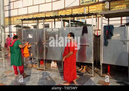 Les femmes attendent devant les vestiaires après un bain de purification dans le Gange Banque D'Images