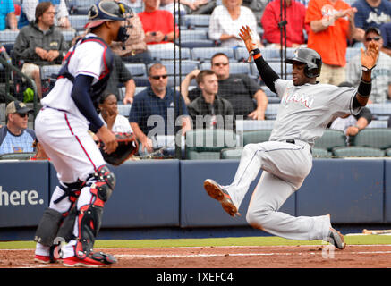 Miami Marlins' Adeiny Hechavarria (R) en face de Atlanta Braves catcher Christian Bethancourt sur un double par Dee Gordon lors de la troisième manche à Turner Field à Atlanta en avril 15, 2015. Photo de David Tulis/UPI Banque D'Images