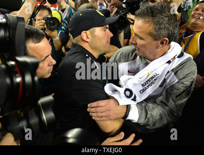 Ohio State Buckeyes urbain entraîneur-chef Meyer (R), serre la main avec l'Oregon Ducks entraîneur en chef Mark Helfrich après les Buckeyes défait les Oregon Ducks 42-20 pour gagner le match de Football Championnat National, à Arlington, au Texas le 12 janvier 2015. Photo par Kevin Dietsch/UPI Banque D'Images