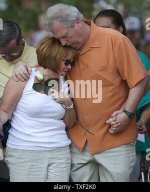 Les membres des familles des victimes hug lors d'une veillée de prière en face du centre municipal à Aurora, Colorado Le 22 juillet 2012. Douze spectateurs ont été tués par balle avec un maximum de cinquante neuf plus de personnes blessées de la Century 16 salles de cinéma de l''Aurora Town Center Mall. Les victimes étaient inscrits à un minuit première du nouveau film de Batman. Le suspect, James Eagan Holmes, aurait jeté une bombe fumigène et a ouvert le feu sur les spectateurs. UPI/Gary C. Caskey Banque D'Images