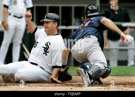 White Sox de Chicago's Jim Thome (L) cours des Twins du Minnesota catcher Joe Mauer après Jermaine Dye a frappé une seule au cours de la deuxième manche à Chicago le 9 juin 2008. (Photo d'UPI/Brian Kersey) Banque D'Images