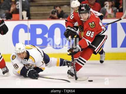L'aile droite des Nashville Predators Brandon Yip (L) qu'il tombe, il essaie de voler la rondelle de l'aile droite des Blackhawks de Chicago Patrick Kane au cours de la deuxième période à l'United Center, 25 mars 2012 à Chicago. UPI/Brian Kersey Banque D'Images