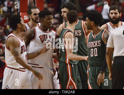 Milwaukee Bucks guard O.J. Mayo (R) et Chicago Bulls guard Jimmy Butler (3L) doivent être séparés par des coéquipiers après avoir échangé des mots au cours du deuxième trimestre de match 5 du premier tour des playoffs NBA à l'United Center le 27 avril 2015 à Chicago. Butler et Mayo sont appelés tous deux pour fautes techniques. Photo de Brian Kersey/UPI Banque D'Images