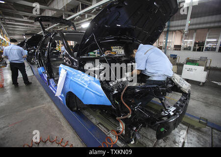 Les travailleurs chinois assemblage Ford et Volvo Cars à Chang'an d'une usine de montage automobile Ford à Chongqing le 25 août 2010. Chang'an Ford Ford Motor Company's Chine location de décision joint venture. La Chine est le marché automobile par nombre de véhicules vendus, et les constructeurs automobiles sont à la recherche pour le pays à revenus d'entraînement au milieu de la faiblesse de la demande mondiale. UPI/Stephen Shaver Banque D'Images
