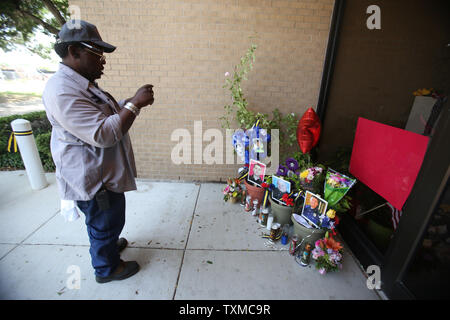 Un homme s'arrête devant un mémorial de fortune qui repose à l'extérieur les portes avant du Dallas Police Department Division patrouille sud-ouest sur l'Avenue de l'Illinois le 11 juillet 2016. Micheal agents Krol, Lorne Ahrens et Patrick Zamarippa étaient toutes fondées sur le sud-ouest de la division de patrouille. Les trois, plus l'agent de la DPD et Michael Smith Agent DART BrettThompson ont tous été tués après Xavier Micah Johnson a ouvert le feu à partir d'un deuxième étage parking garage lors d'une réunion pacifique 'Black vit" de mars. Photo de Chris McGathey/UPI Banque D'Images