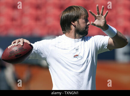 In this Aug. 18, 2012, photo, Denver Broncos quarterback Caleb Hanie warms  up for NFL football preseason game against the Seattle Seahawks in Denver.  The Dallas Cowboys have added another quarterback with