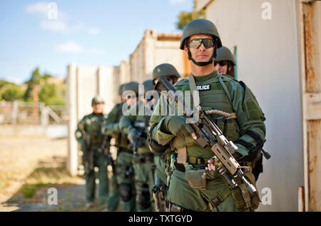 Groupe d'agents de police sur le point d'entrer dans un bâtiment au cours d'un exercice à un centre de formation. Banque D'Images