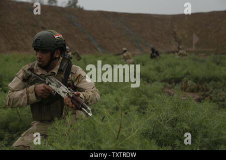 Un soldat irakien avec le 4e Bataillon, 23e Brigade de l'armée irakienne, les scouts à un chemin pour son équipe lors d'une patrouille simulée pour une évaluation des compétences au Camp Taji, l'Iraq, le 28 mars 2016. Le Groupe de travail a procédé à l'évaluation des compétences de Taji pour évaluer l'soldiersÕ la compétence dans des tâches de combat de base. Par le biais d'aider et de conseiller, et de renforcer les capacités des partenaires missions, le Combined Joint Task Force C ResolveÕs inhérent coalition multinationale a formé plus de 20.7K du personnel à l'encontre de l'État islamique d'Irak et du Levant. Photo par le Sgt. Paul Vente/U.S. Army/UPI Banque D'Images