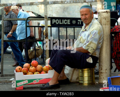 Un Israélien vend des grenades dans le marché Mahane Yehuda à Jérusalem, le 20 septembre 2006. Les Israéliens consomment des grenades lors de Roch hachana, le Nouvel An juif, qui commence le vendredi au coucher du soleil et dure deux jours. (Photo d'UPI/Debbie Hill) Banque D'Images