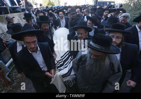 Les juifs ultra-orthodoxes portent le corps recouvert de châle de prière victime de la terreur le Rabbin Moshe Twersky avant ses funérailles à Jérusalem, Israël, le 18 novembre 2014. Le rabbin Twersky a été l'un des quatre Juifs tués lors de deux Palestiniens de Jérusalem est entré dans une synagogue le mardi matin et a attaqué des fidèles juifs avec des couteaux, des haches et des armes à feu, tuant quatre personnes, avant d'être abattu par la police israélienne. UPI/Stringer Banque D'Images