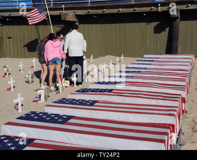 Un groupe de gens ont-ils des mains en prière à l'ouest d'Arlington Memorial Project à Santa Monica, Californie le 29 mai 2011. Le 12 cercueils fantaisie qu'ils sont à côté de représenter les soldats tués cette semaine : 10 en Afghanistan et en Iraq 2. UPI /Jim Ruymen) Banque D'Images