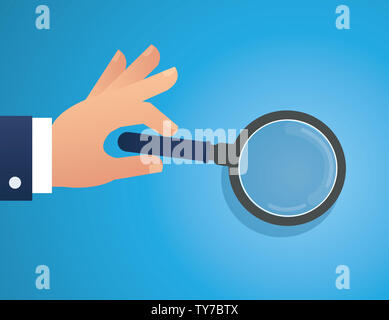 Main tenant la loupe Banque D'Images