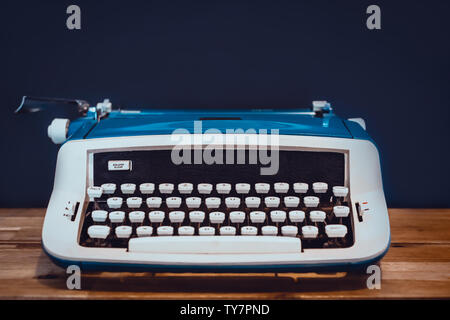 Close Up of Vintage Typewriter sur bureau en bois avec fond noir Banque D'Images