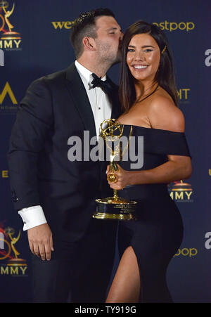 Jacqueline MacInnes Wood (R) obtient un baiser de son mari qu'elle est titulaire d'Elan Ruspoli Daytime Emmy pour son actrice principale remarquable dans une série dramatique en coulisses dans la salle de presse de la 46e Journée annuelle de Emmy Awards tenue à la Pasadena Civic Auditorium à Pasadena, Californie le 5 mai 2019. Photo de Chris Chew/UPI Banque D'Images