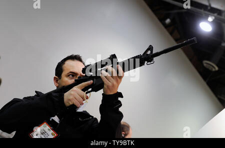 Présence Evandro Silva du Brésil examine une carabine site sur le Trijicon stand à la Fondation nationale de tir sportif tir annuel de la 35e, la chasse, le commerce extérieur (SHOT) Spectacle au Sands Expo Convention Center le 16 janvier 2013 à Las Vegas. Le coup de feu est le plus important rassemblement annuel de tir professionnels avec plus de 1 600 exposants et 60 000 visiteurs. UPI/David Becker Banque D'Images